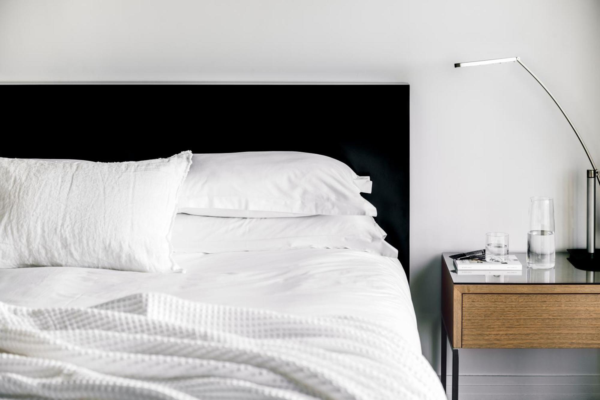 The Como Melbourne Exterior photo A bed with a black headboard